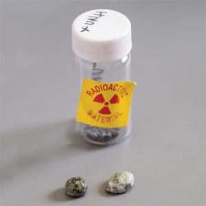 Single vial containing samples and a radioactive sticker on the glass.