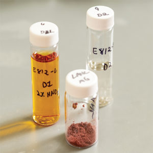 Three glass vials of samples.
