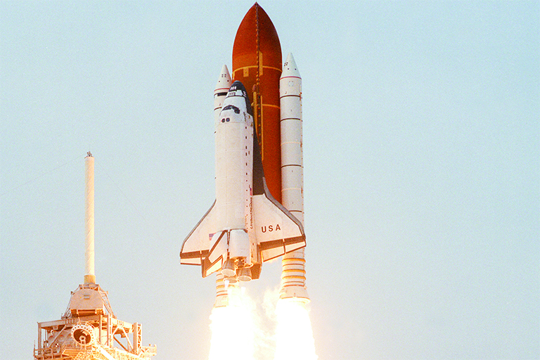 Space shuttle lifts off.