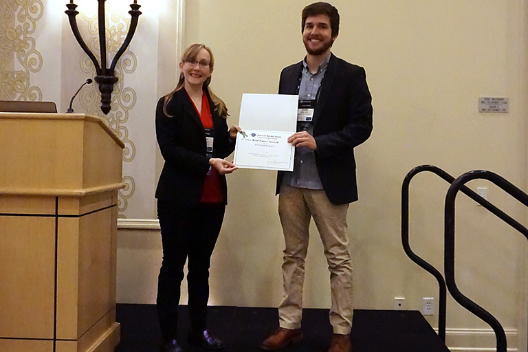 Jonah Duran accepts the Best Paper Award from an ANS representative.