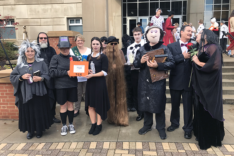 Members of the department dressed as "The Addams Family" pose with their second place award.