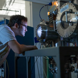 Shawn Zamperini looks inside lab equipment.