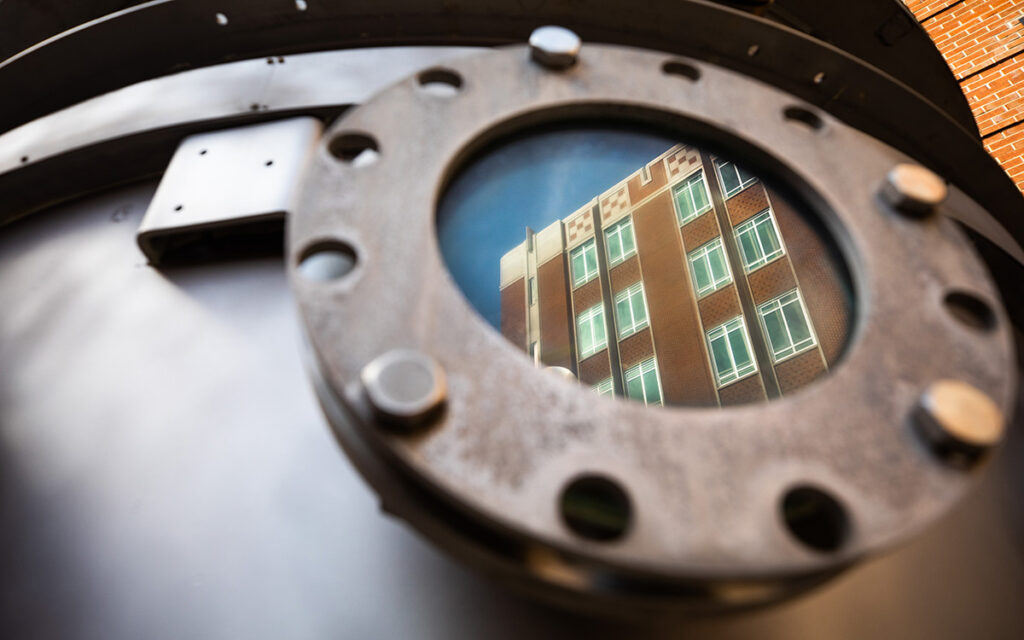 The reflection of the Zeanah Engineering Complex is seen within the glass of a faux-nuclear reactor located at the University of Tennessee, Knoxville.