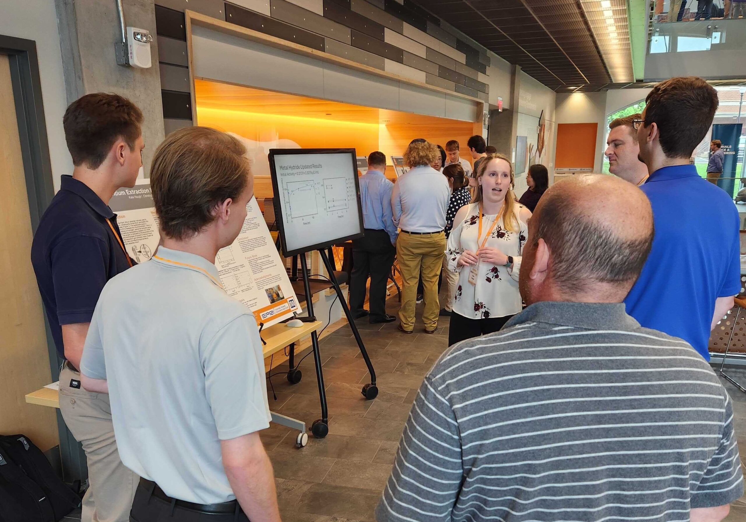 TEW team presenting their project to people at the 2024 Senior Design Showcase in the Zeanah Engineering Complex building