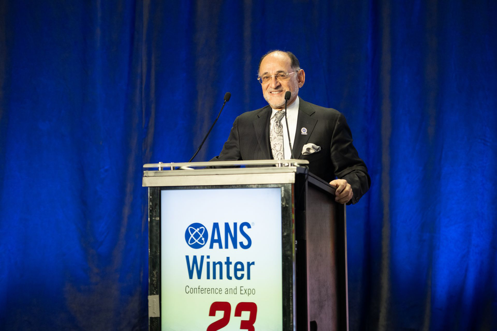 Hashem M. Hashemian speaking behind a podium at an ANS event