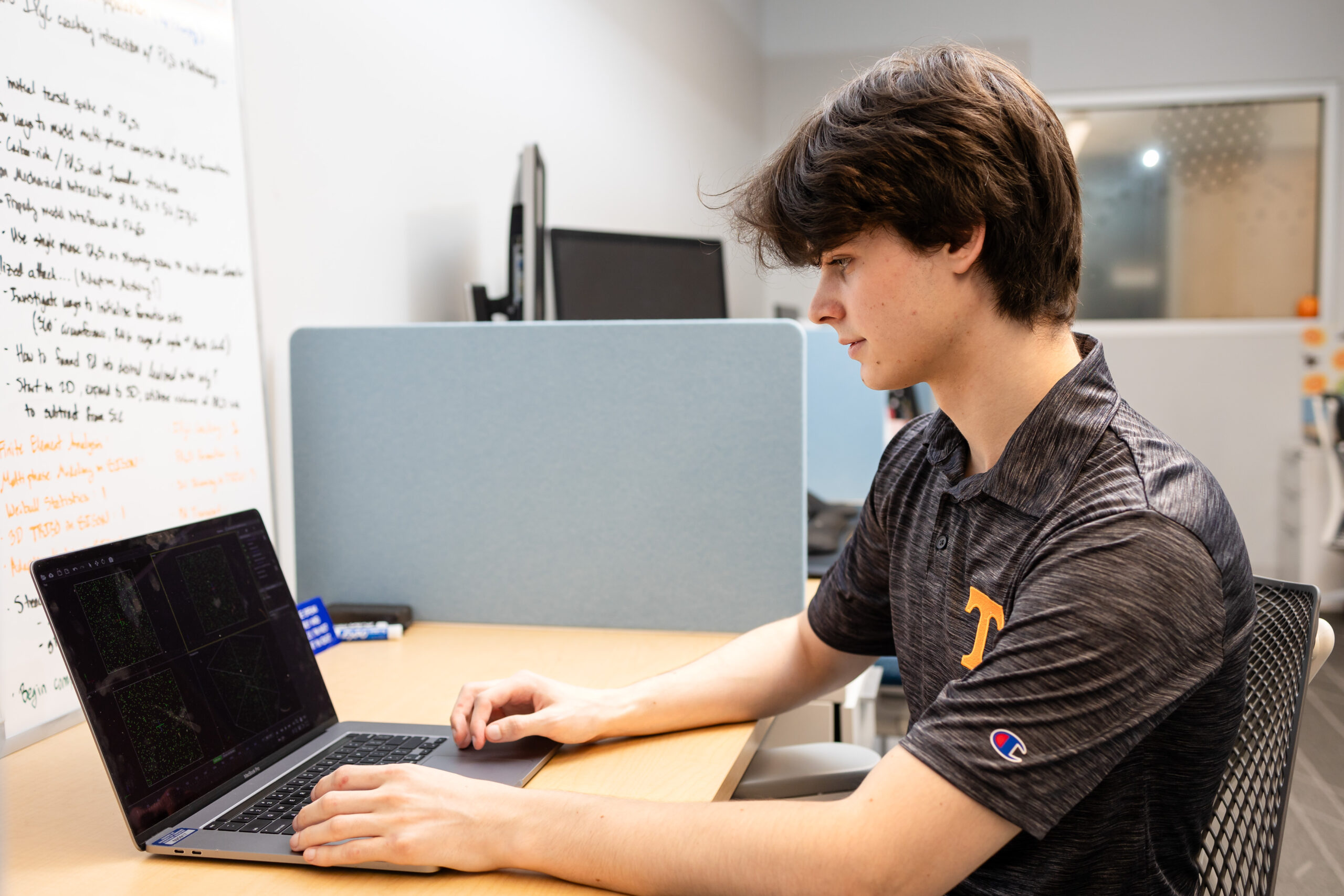 Samuel Haid working on a computer in Sophie Blondel's lab