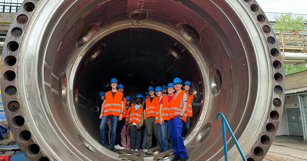 study abroad nuclear engineering students visiting Skoda Nuclear Machinery standing in a vessel for a nuclear reactor