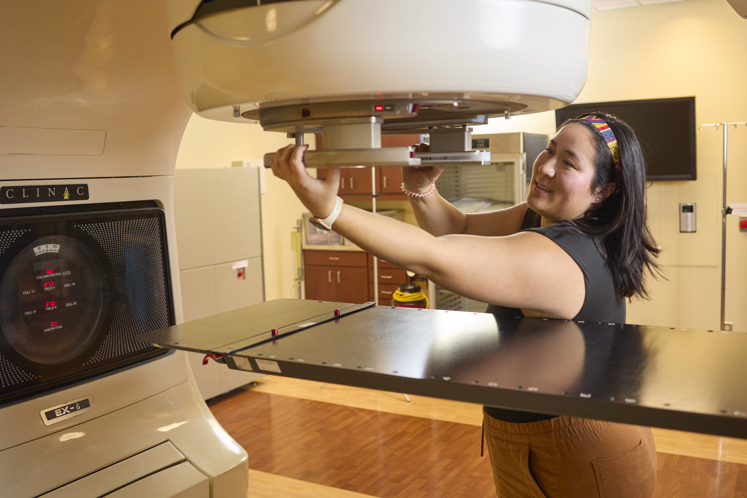 woman setting up machine as a part of the medical physics program