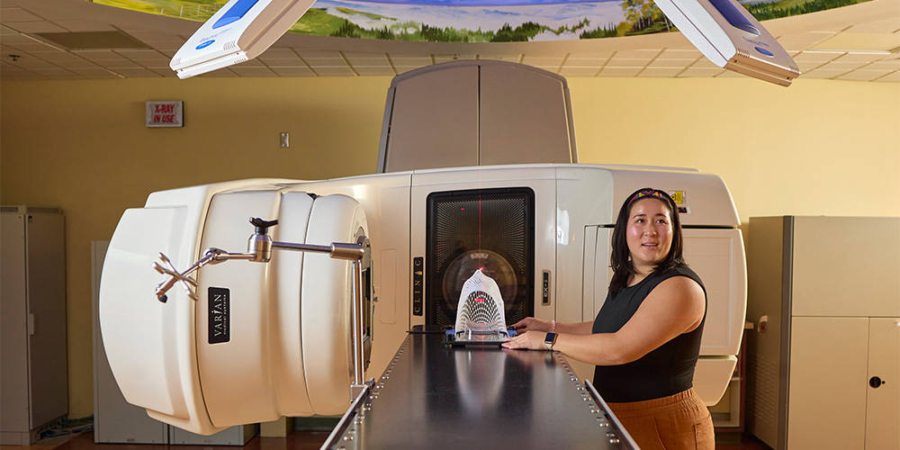 woman working with a machine in the medical physics program at the University of Tennessee