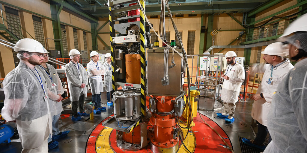 undergraduate students learning about a nuclear reactor on a study abroad trip