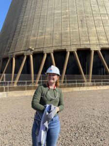 Madison Vandergriff standing in front of a nuclear plant