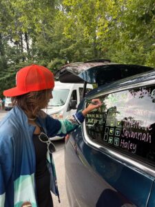 Caitlyn Parsons marking her race time off on a car window